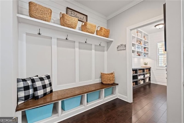 mudroom featuring ornamental molding and dark wood-type flooring