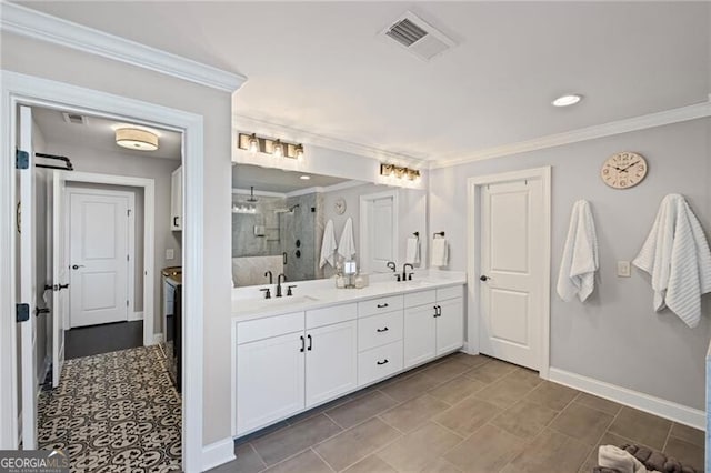 full bathroom featuring a shower stall, visible vents, crown molding, and a sink