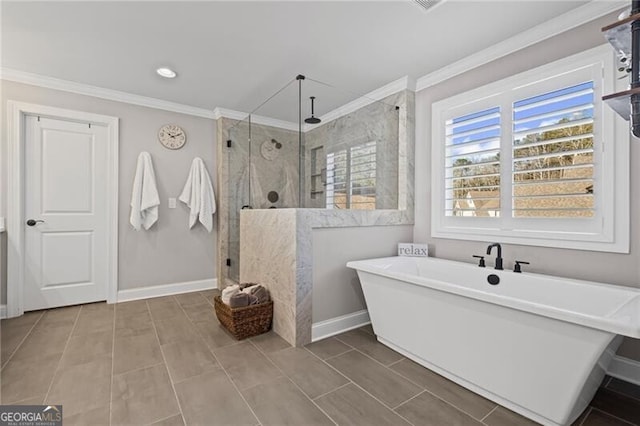 full bathroom with baseboards, a soaking tub, crown molding, and a shower stall