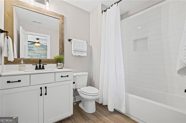 full bathroom with vanity, toilet, visible vents, ceiling fan, and wood finished floors