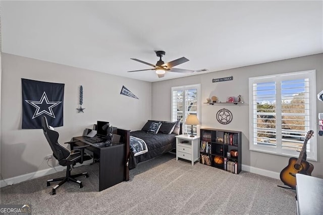 carpeted bedroom with baseboards, ceiling fan, and visible vents