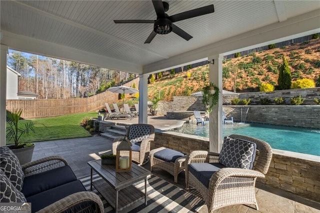 view of patio / terrace featuring a ceiling fan, a fenced backyard, a fenced in pool, and an outdoor living space