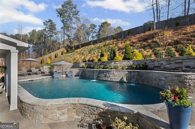 view of swimming pool with a fenced backyard, a fenced in pool, and a patio
