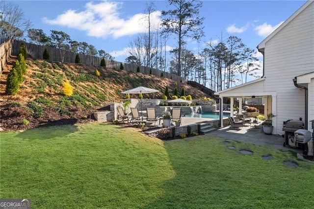 view of yard featuring fence, an outdoor pool, and a patio
