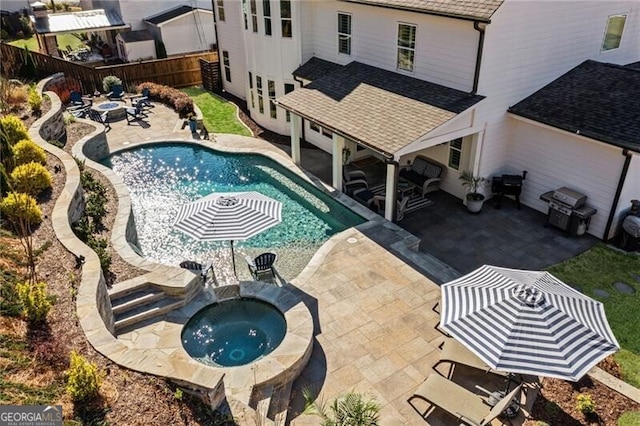 view of swimming pool featuring a grill, a patio, a fenced backyard, an outdoor fire pit, and an in ground hot tub