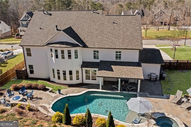 view of swimming pool with a fenced backyard, a fenced in pool, a yard, and a patio area