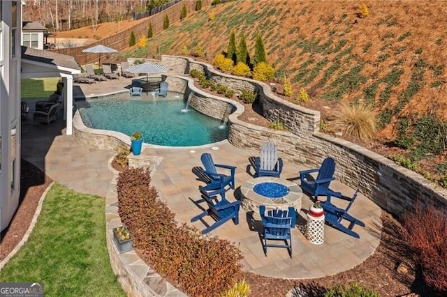 view of swimming pool with a patio, an outdoor fire pit, fence, and a fenced in pool