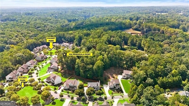 birds eye view of property featuring a residential view and a forest view