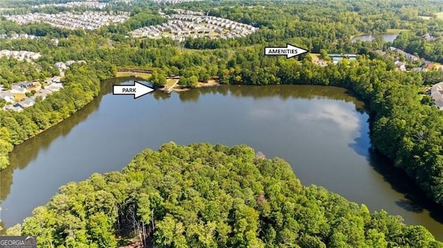 aerial view featuring a water view and a wooded view