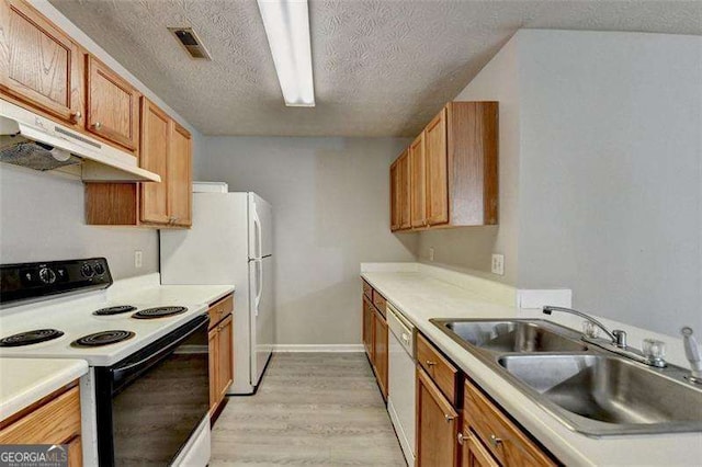 2892 Norfair Loop NE, Lithonia, GA 30038 - kitchen with light wood-type flooring, white appliances, under cabinet range hood, a sink, and visible vents