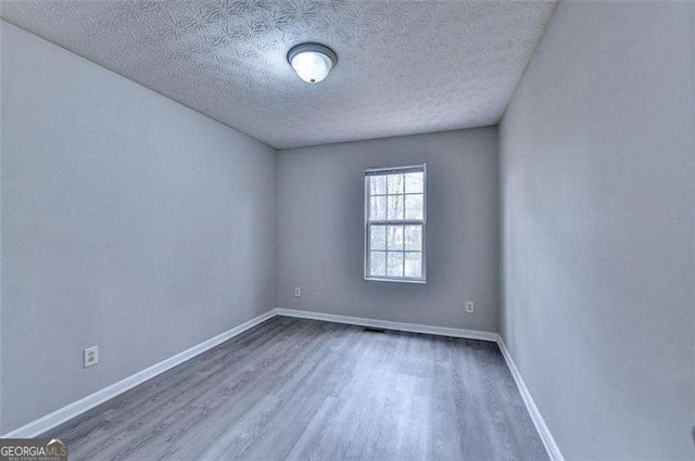 2892 Norfair Loop NE, Lithonia, GA 30038 - empty room featuring baseboards, a textured ceiling, and wood finished floors