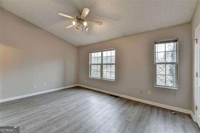 2892 Norfair Loop NE, Lithonia, GA 30038 - spare room with a wealth of natural light, visible vents, wood finished floors, and a ceiling fan