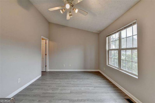 2892 Norfair Loop NE, Lithonia, GA 30038 - empty room with lofted ceiling, a wealth of natural light, wood finished floors, and ceiling fan