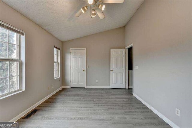 2892 Norfair Loop NE, Lithonia, GA 30038 - interior space with multiple windows, wood finished floors, lofted ceiling, and visible vents