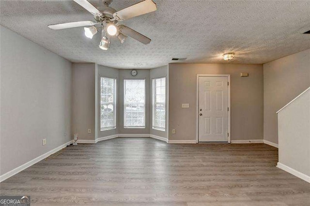 2892 Norfair Loop NE, Lithonia, GA 30038 - spare room featuring wood finished floors, a textured ceiling, baseboards, visible vents, and ceiling fan