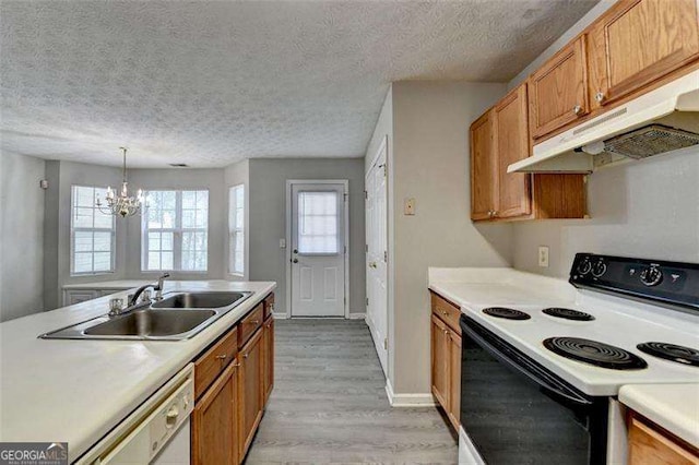 2892 Norfair Loop NE, Lithonia, GA 30038 - kitchen featuring light countertops, under cabinet range hood, a sink, white dishwasher, and range with electric cooktop
