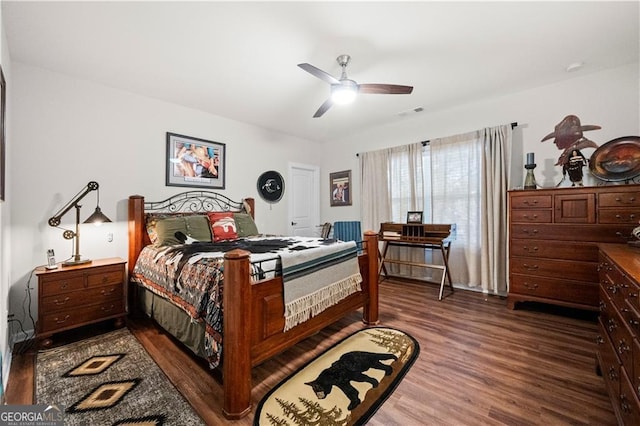 bedroom with dark wood finished floors, a ceiling fan, and visible vents