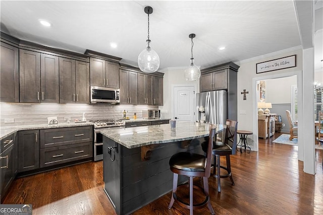 kitchen with backsplash, light stone countertops, crown molding, dark brown cabinetry, and appliances with stainless steel finishes