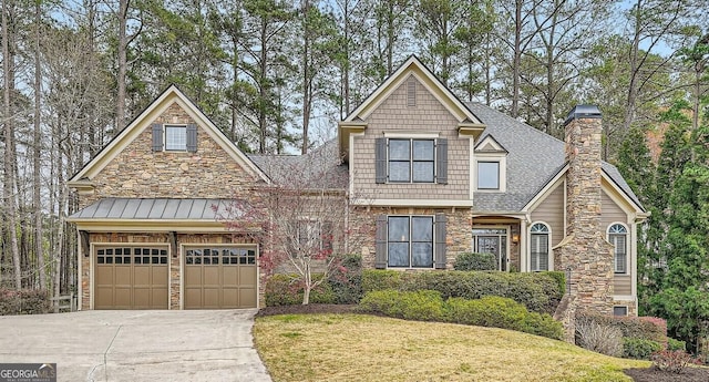 craftsman house with driveway, a chimney, a standing seam roof, roof with shingles, and a garage