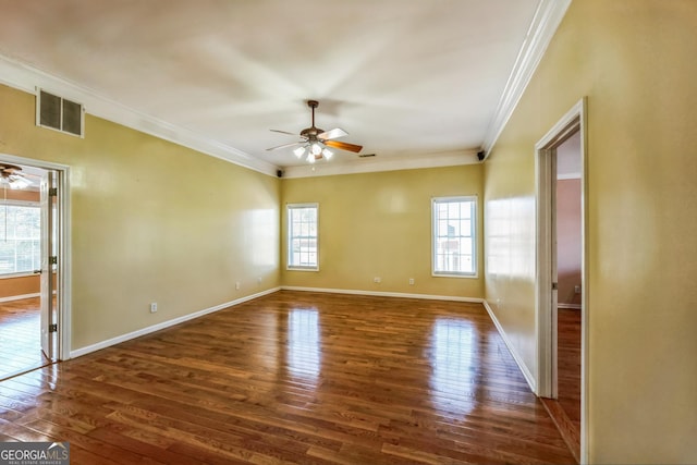 unfurnished room with dark wood-style floors, visible vents, ornamental molding, and a ceiling fan