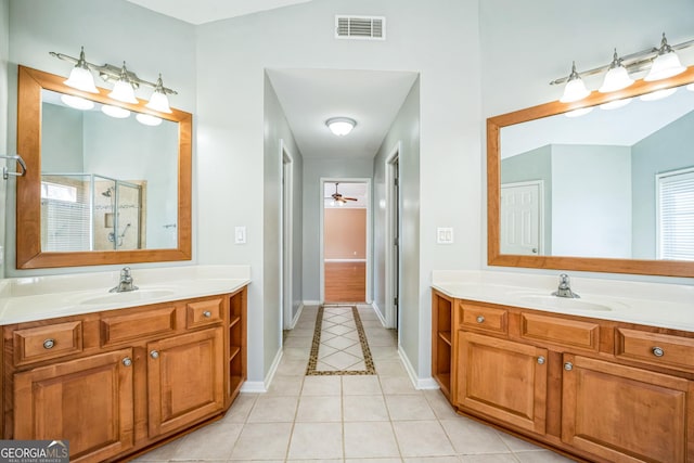 bathroom with a sink, visible vents, a stall shower, and tile patterned flooring