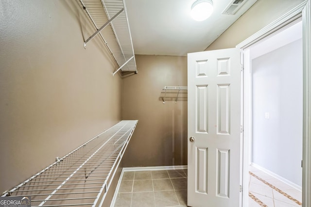 spacious closet featuring light tile patterned flooring and visible vents