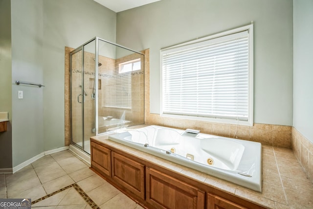 full bath featuring tile patterned floors, a whirlpool tub, a stall shower, and baseboards