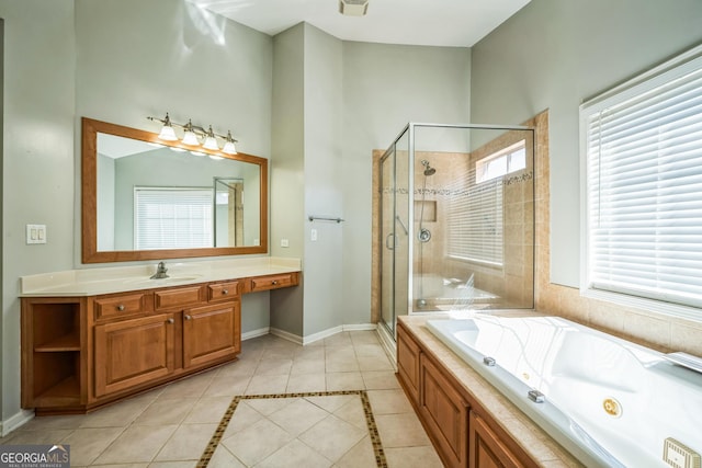 bathroom with a stall shower, tile patterned floors, a tub with jets, and baseboards
