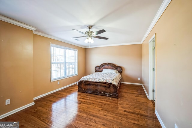 bedroom with baseboards, crown molding, wood finished floors, and ceiling fan