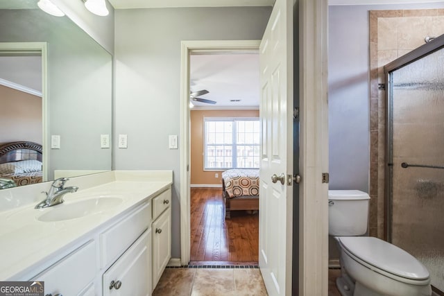 ensuite bathroom with connected bathroom, a stall shower, toilet, and vanity