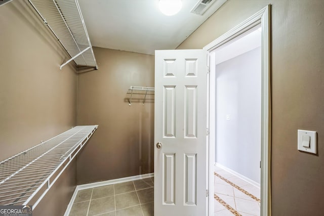 spacious closet featuring tile patterned floors and visible vents