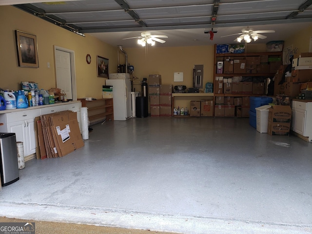 garage featuring a ceiling fan and freestanding refrigerator