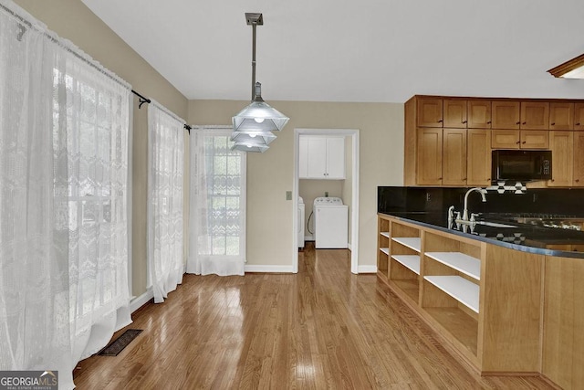 7037 Waters Edge Dr, Stone Mountain, GA 30087 - kitchen featuring open shelves, dark countertops, wood finished floors, visible vents, and black microwave