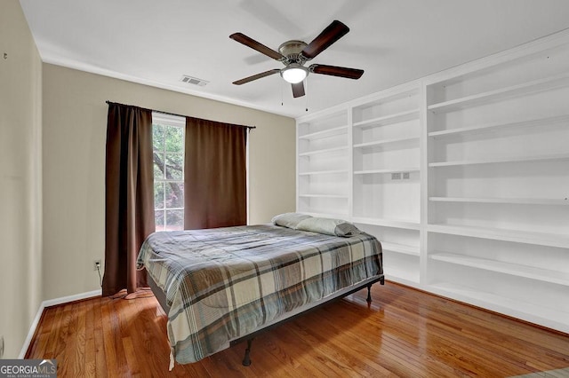 7037 Waters Edge Dr, Stone Mountain, GA 30087 - bedroom featuring baseboards, a ceiling fan, wood finished floors, and visible vents