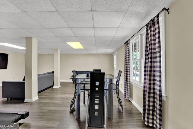 7037 Waters Edge Dr, Stone Mountain, GA 30087 - dining area with baseboards, dark wood-type flooring, and a drop ceiling