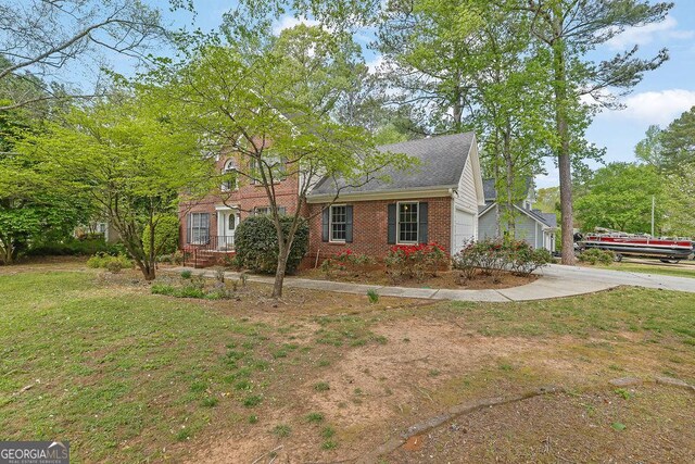 7037 Waters Edge Dr, Stone Mountain, GA 30087 - view of property exterior featuring brick siding, an attached garage, a lawn, and concrete driveway