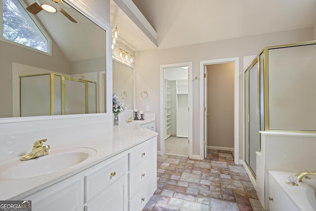 full bath with stone finish flooring, ceiling fan, a stall shower, and lofted ceiling