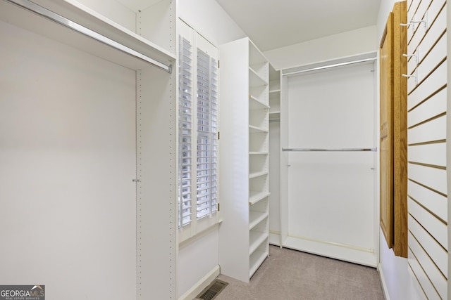 spacious closet with visible vents and carpet
