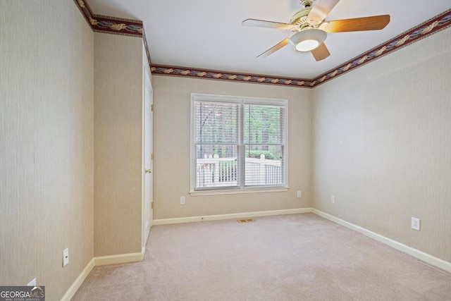 unfurnished room featuring visible vents, baseboards, a ceiling fan, and carpet flooring