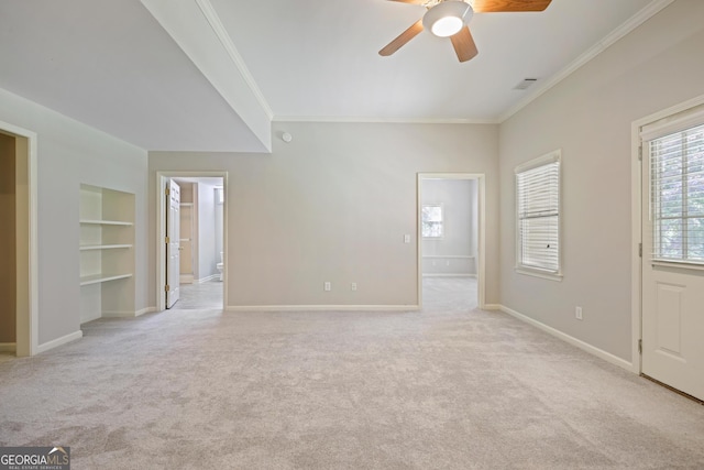 interior space featuring built in features, light colored carpet, a ceiling fan, and crown molding
