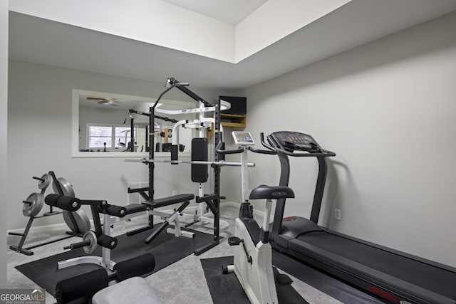 exercise room with baseboards and a ceiling fan