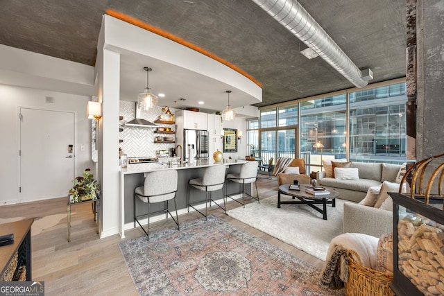 living room featuring expansive windows and light wood-style flooring