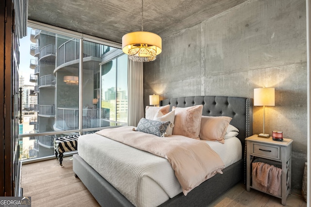 bedroom with wood finished floors and multiple windows