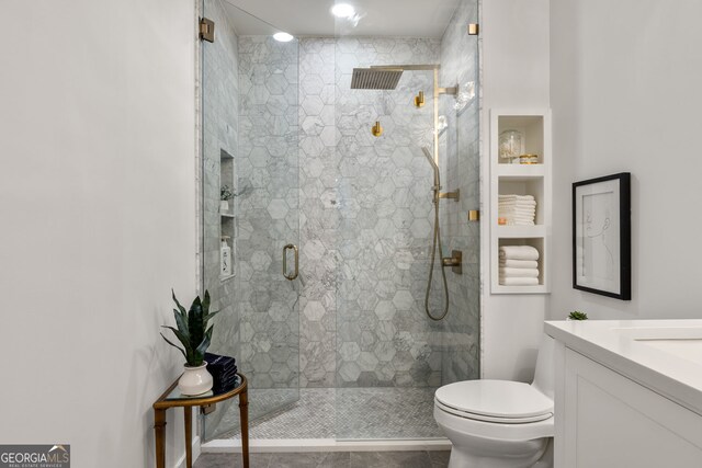 full bath with toilet, a stall shower, tile patterned floors, and vanity