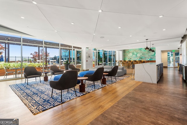 interior space with recessed lighting, floor to ceiling windows, and wood finished floors