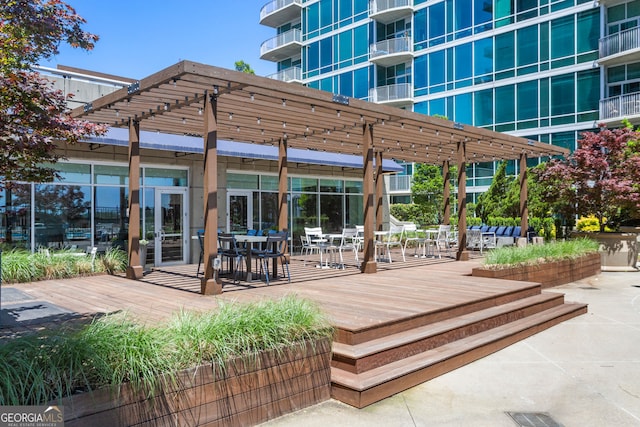 wooden terrace featuring outdoor dining space and a pergola