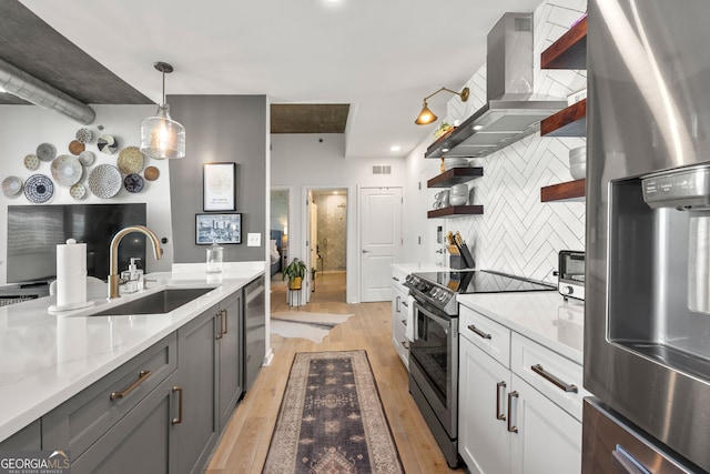 kitchen with decorative backsplash, open shelves, light wood-style flooring, island range hood, and appliances with stainless steel finishes