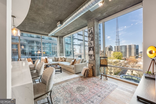 sunroom / solarium featuring a view of city and a healthy amount of sunlight