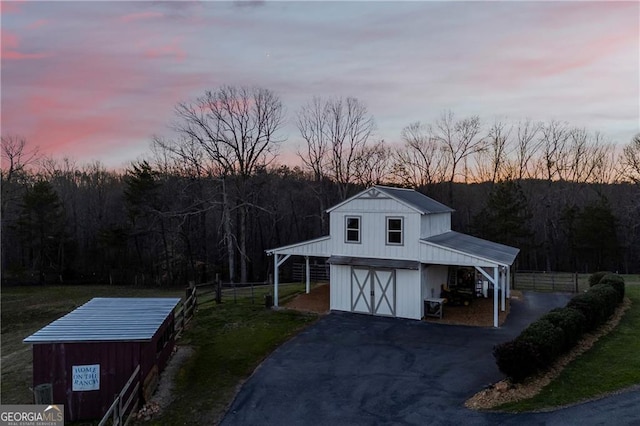 1759 Moccasin Gap Rd, Lula, GA 30554 - outdoor structure at dusk with fence, driveway, and a wooded view