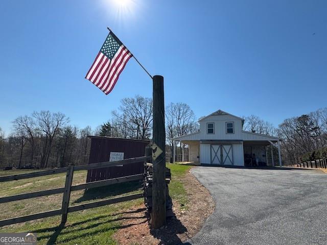 1759 Moccasin Gap Rd, Lula, GA 30554 - view of front of home featuring fence, driveway, and a carport